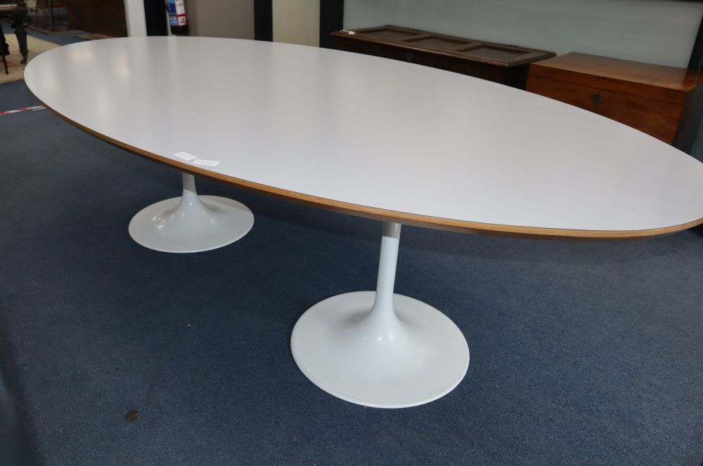 Martino Gamper. An oval white laminate and ply table on two aluminium circular bases, W.250cm, D.120cm, H.70cm